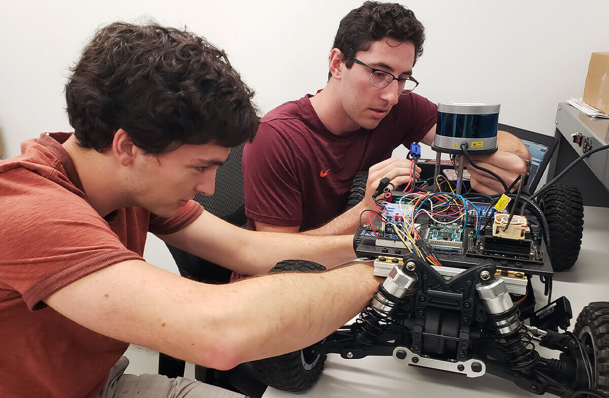 Students working with a remote control vehicle