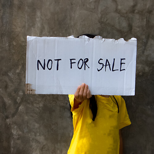 Woman holding not for sale sign
