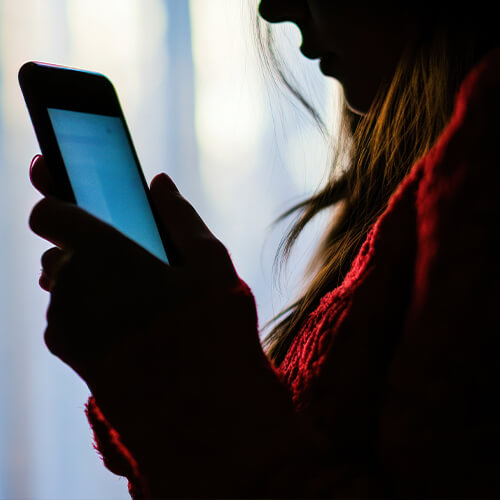 Person on phone in dark room