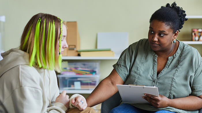School psychologist counseling a teenage girl