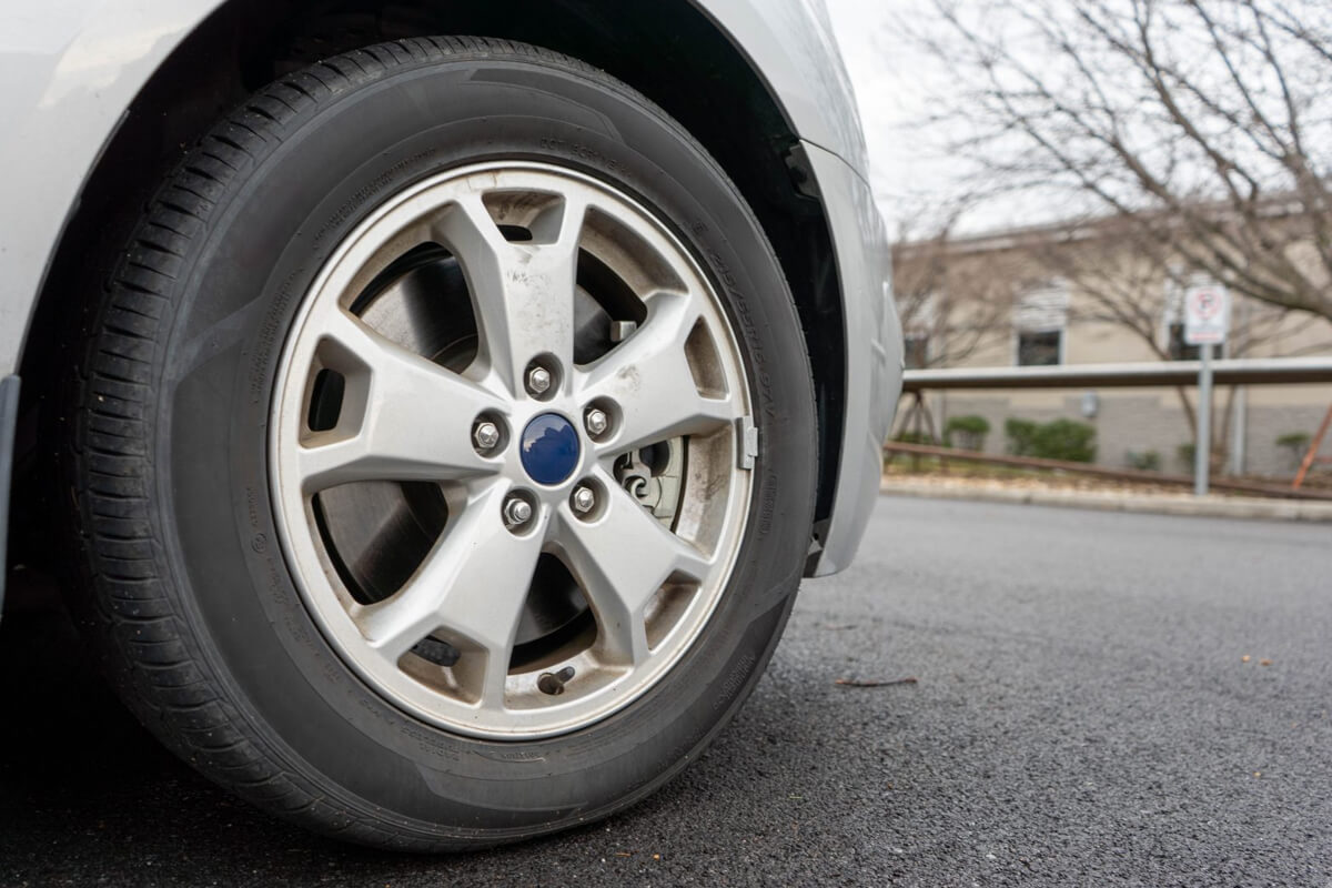 A tire attached to a gray car