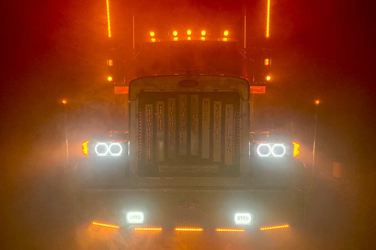 The front of a maroon 1995 Peterbilt semi-truck with Virginia Tech colors and decals