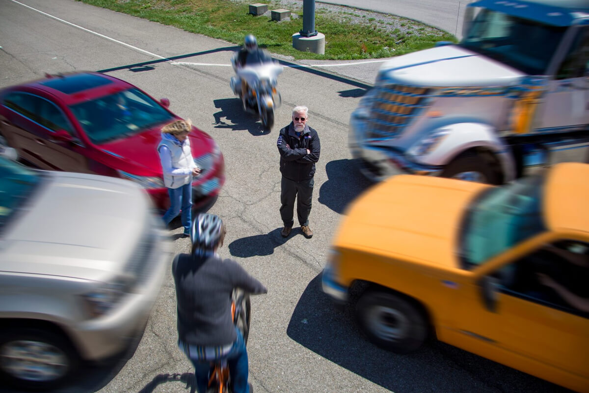 Tom Dingus surrounded by vehicles