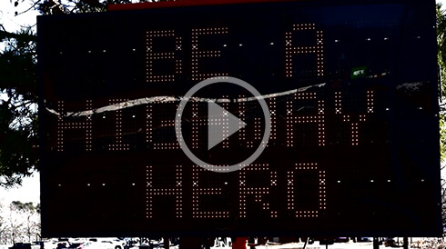 Electronic road sign that says be a highway hero