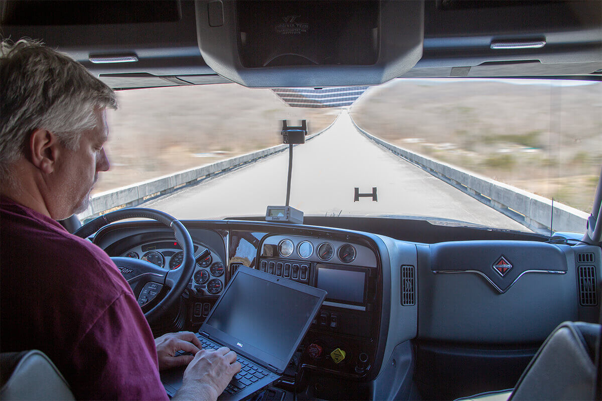 Person using a computer in an automated truck
